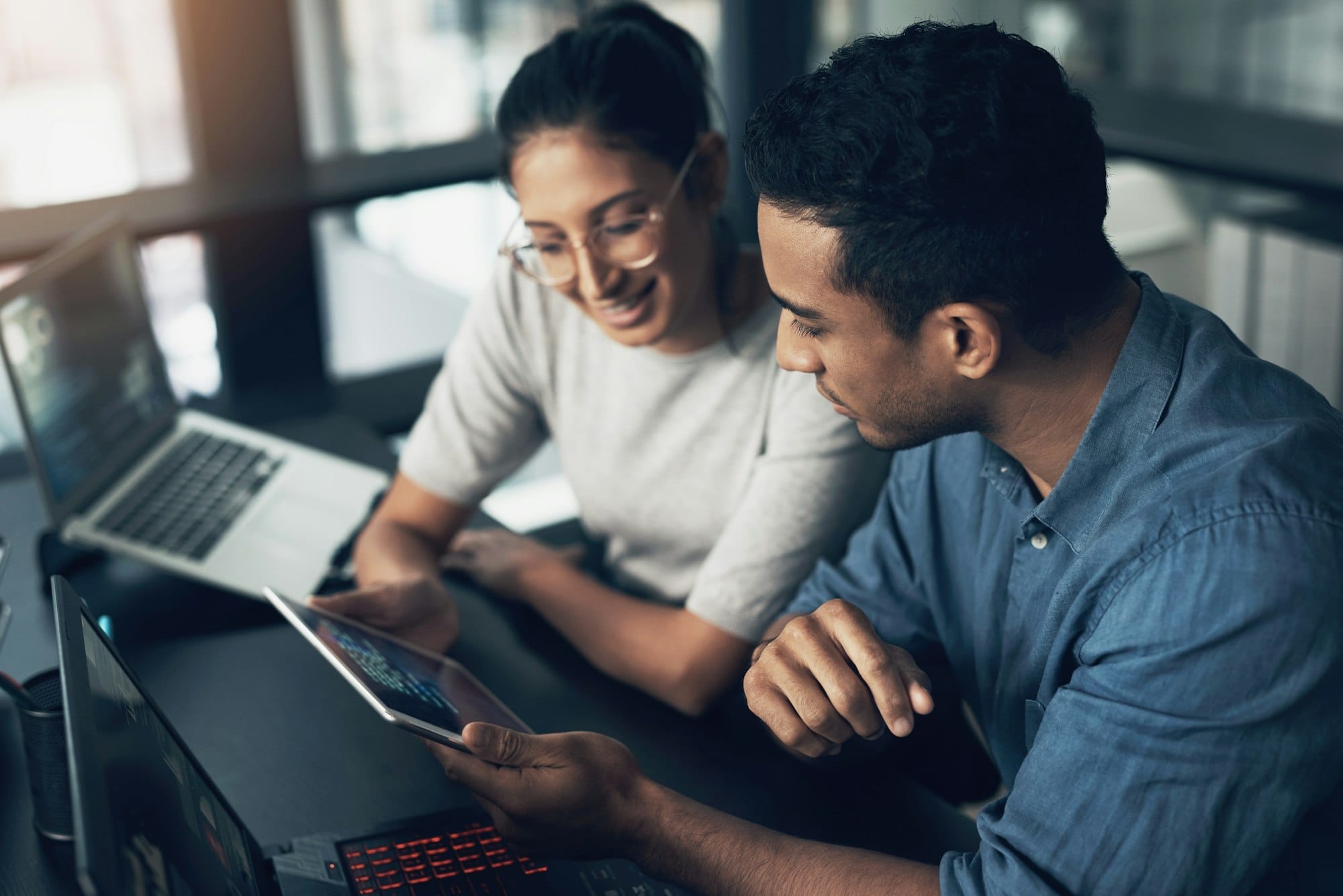 shot of two young workers using a digital tablet in a modern office 1